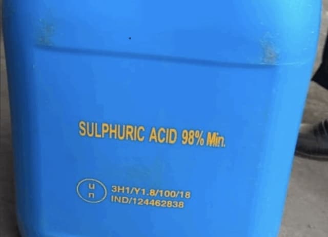 Blue drum labeled Sulphuric Acid 98% Min