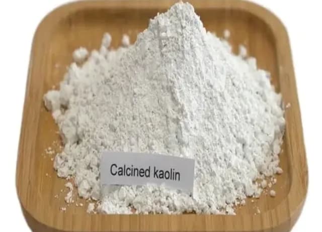 Calcined kaolin white powder in a wooden dish