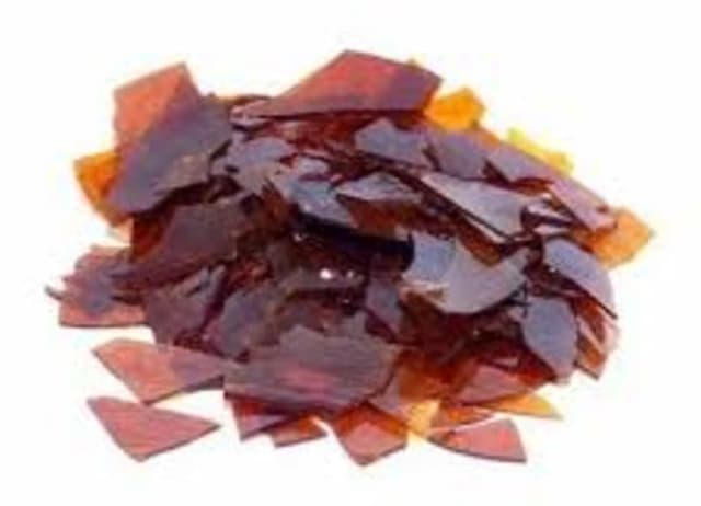 Amber-colored resin flakes used in various industrial applications